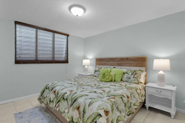 a bedroom with a bed and a lamp