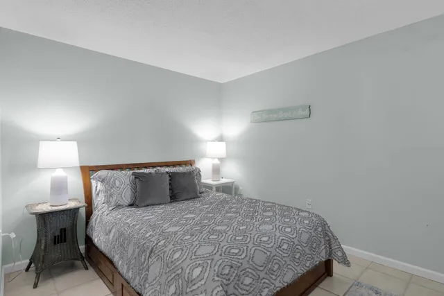 a bedroom with a bed and a lamp