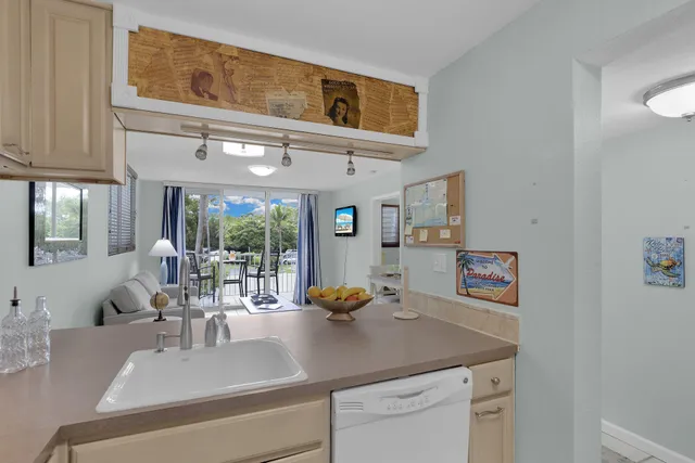 a kitchen with a sink cabinets and window
