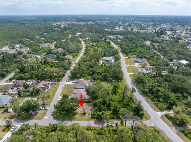 an aerial view of residential house and car parked