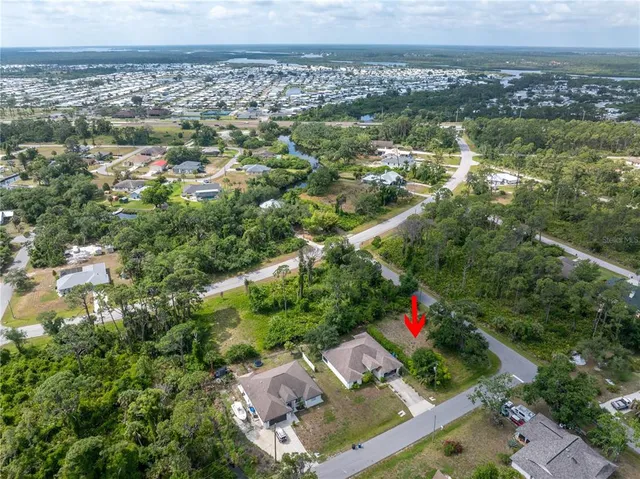 an aerial view of residential houses with city and lake view