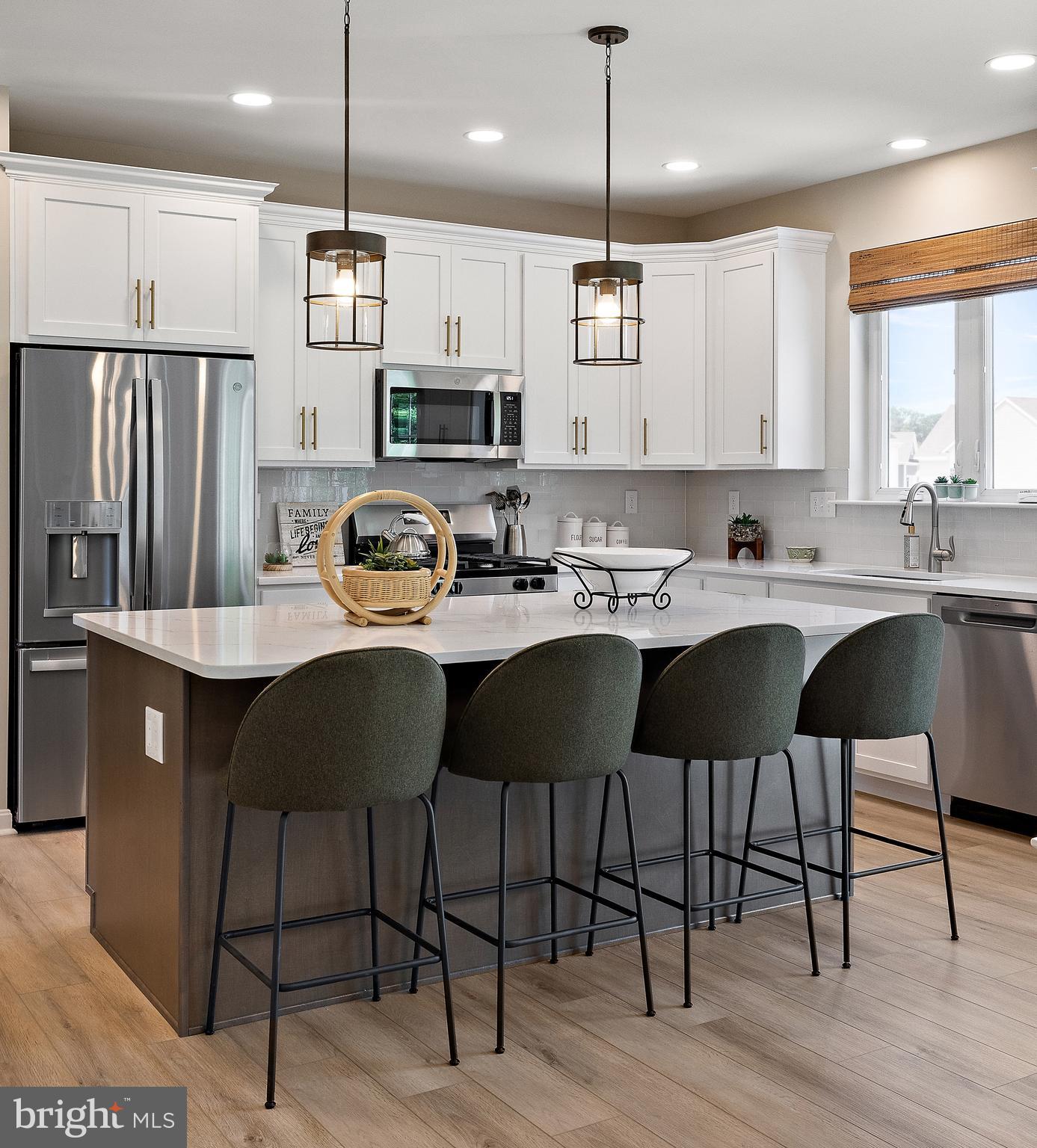 5 B Little Baltimore Road Newark, DE 19711 - Photo 16 of 40 a kitchen with stainless steel appliances granite countertop a sink a stove a refrigerator and a dining table with wooden floor