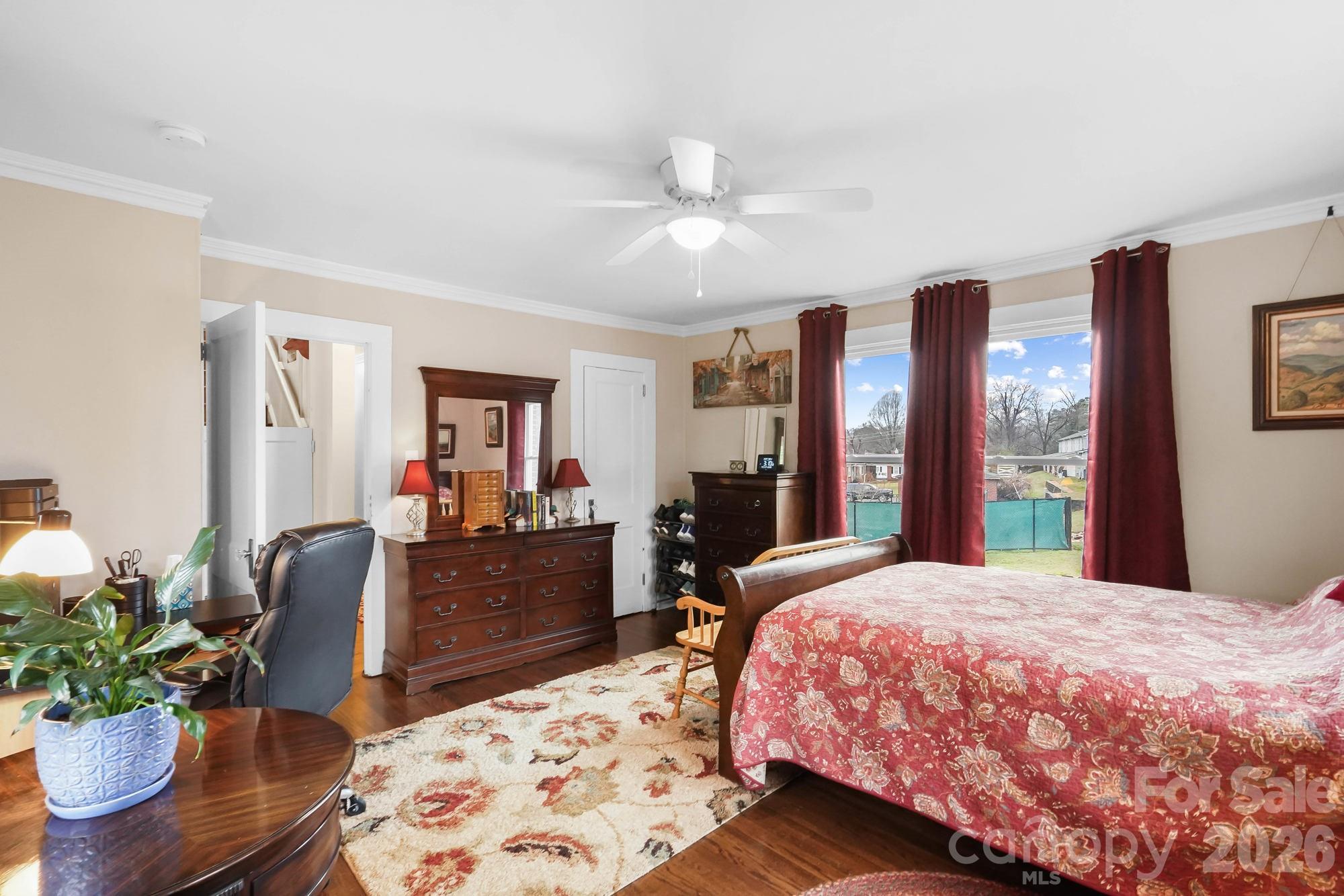 514 Jackson Park Road Kannapolis, NC 28083 - Photo 19 of 48 a bedroom with a large bed and a chandelier