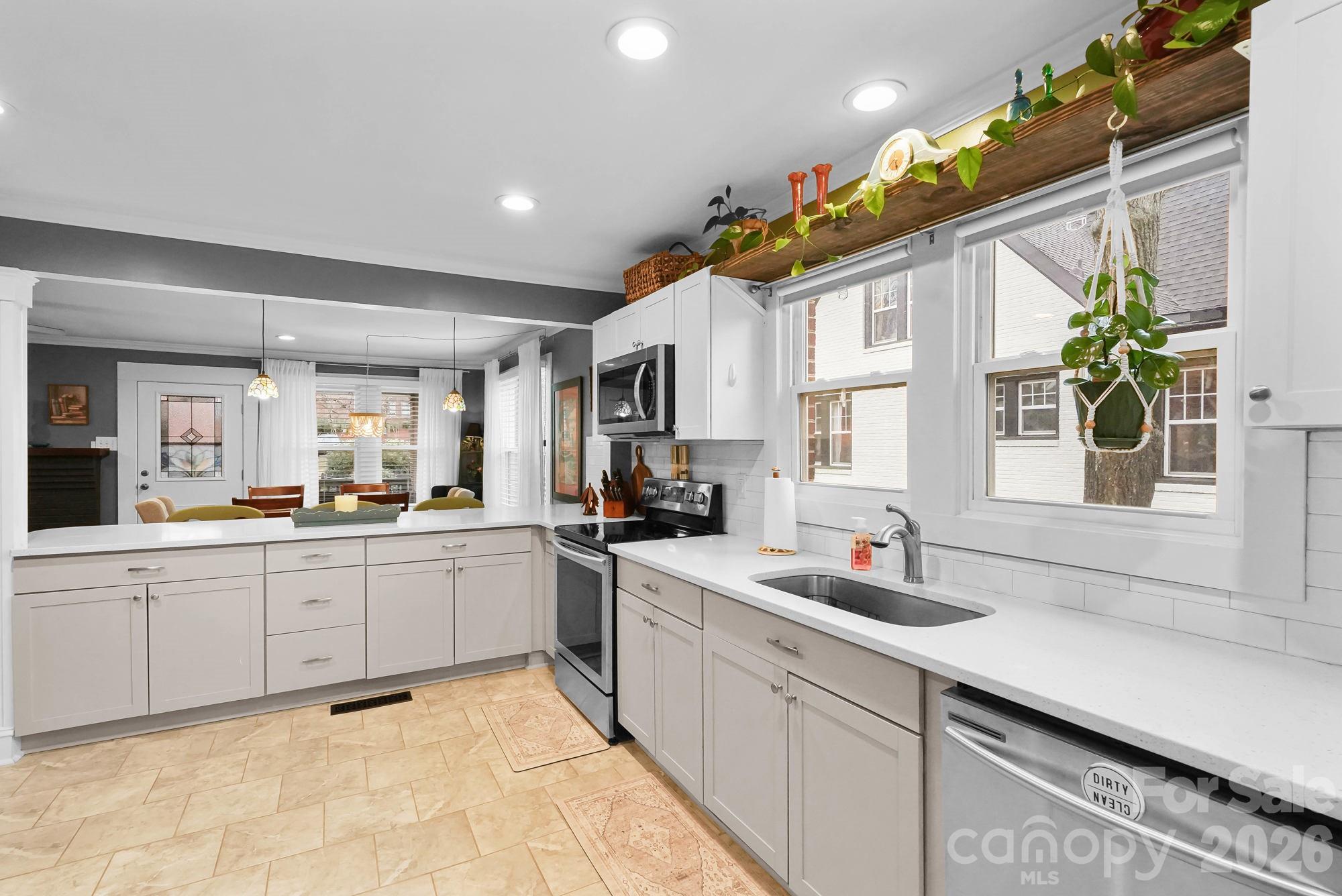 514 Jackson Park Road Kannapolis, NC 28083 - Photo 9 of 48 a kitchen with granite countertop a sink and white cabinets