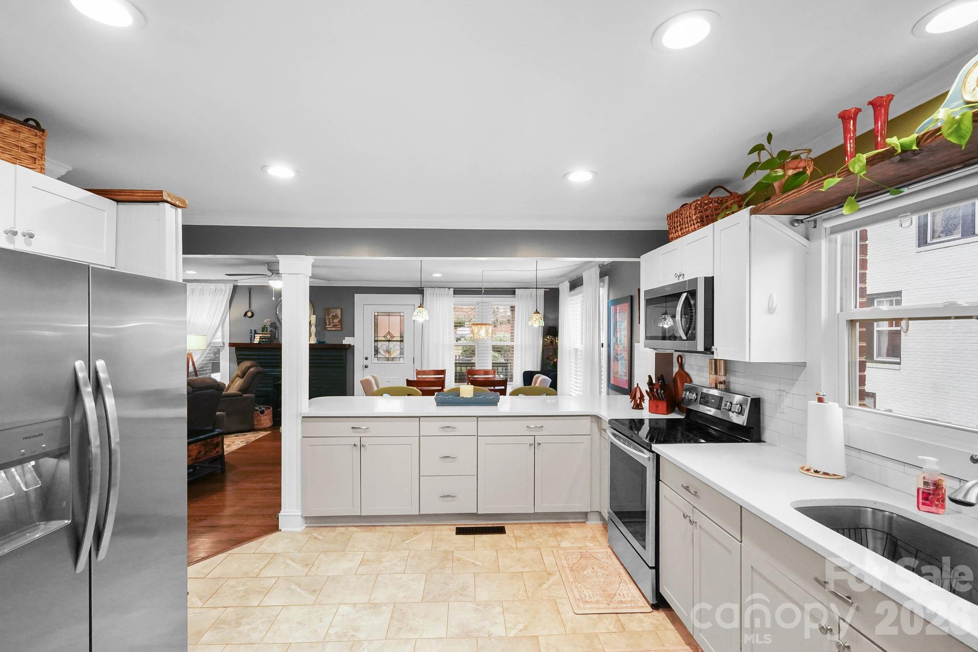 514 Jackson Park Road Kannapolis, NC 28083 - Photo 10 of 48 a kitchen with stainless steel appliances granite countertop a sink counter space cabinets and a large window