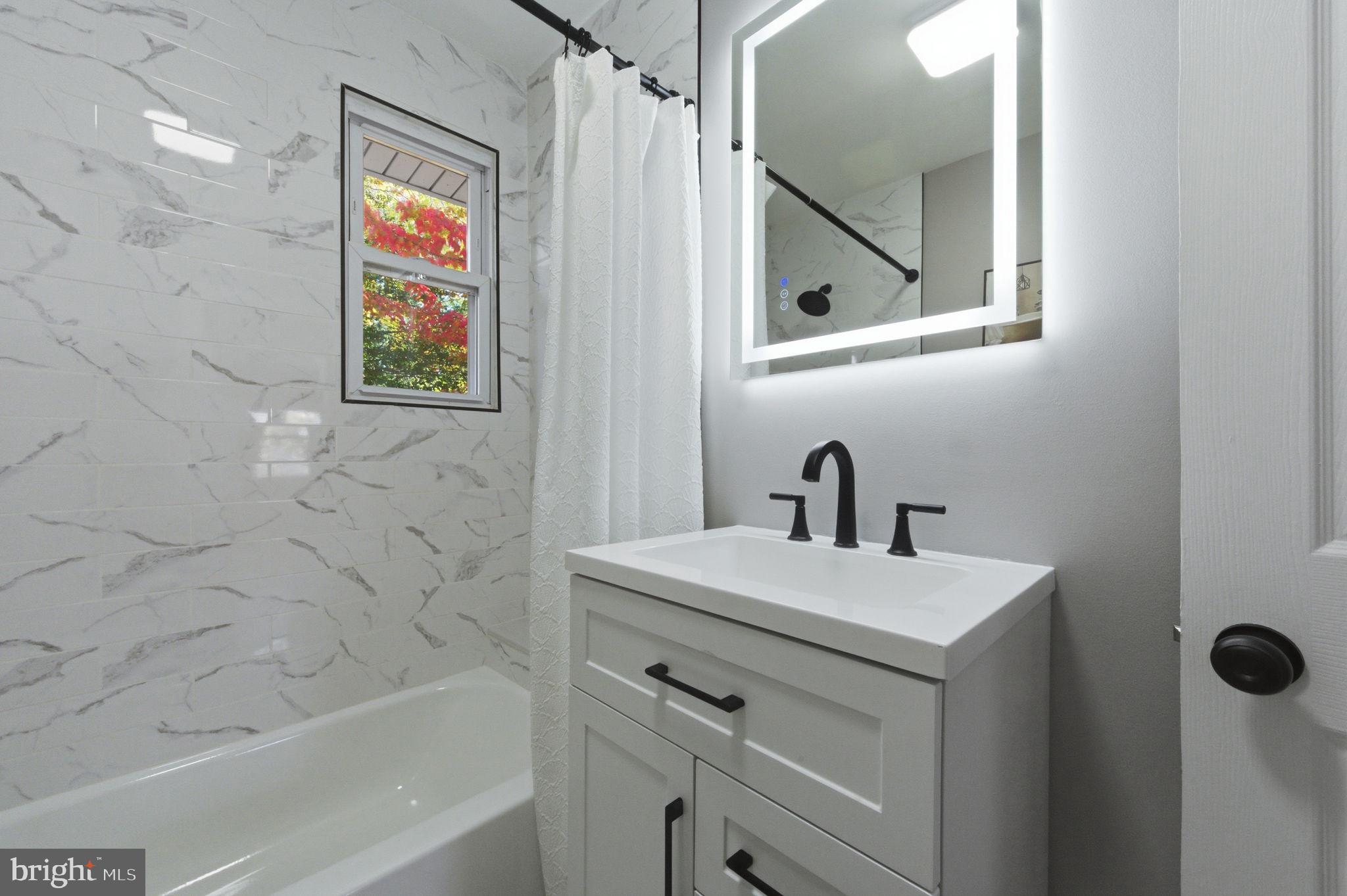 2247 Silverside Road Wilmington, DE 19810 - Photo 15 of 33 a bathroom with a sink a vanity and a mirror