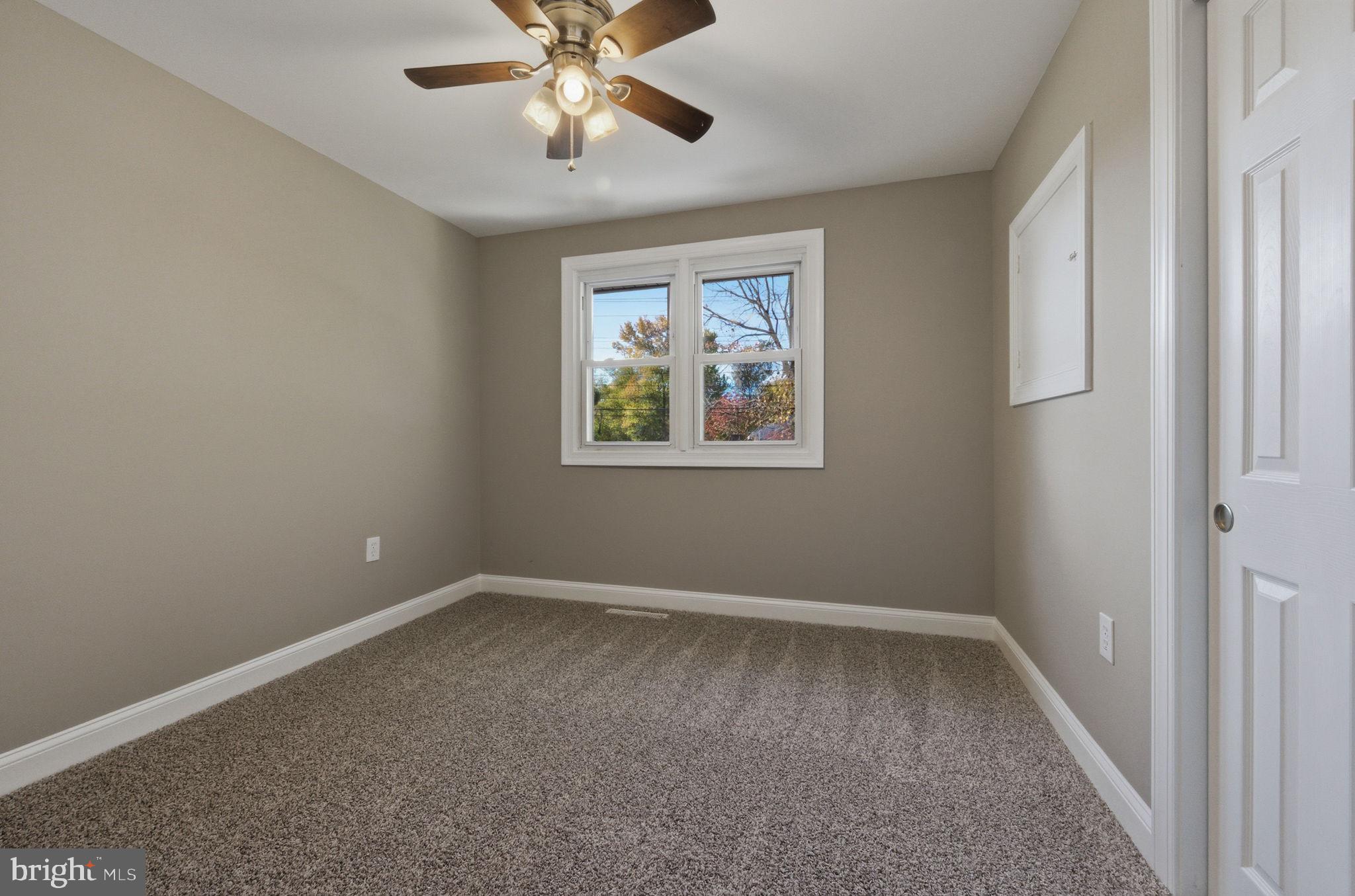 2247 Silverside Road Wilmington, DE 19810 - Photo 28 of 35 an empty room with a window and a fan