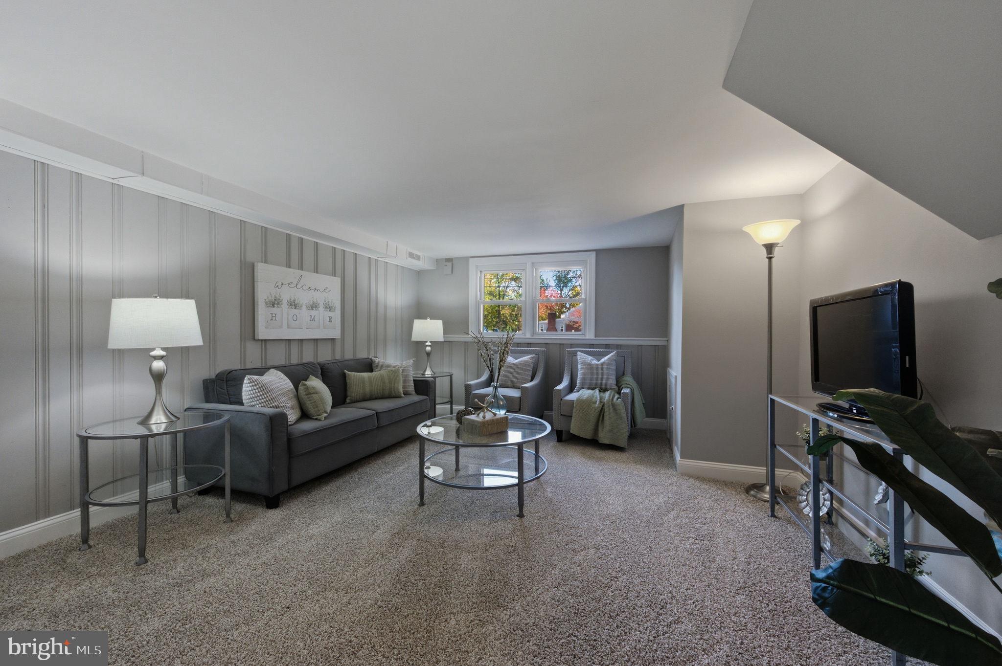 2247 Silverside Road Wilmington, DE 19810 - Photo 31 of 33 a living room with furniture and a flat screen tv