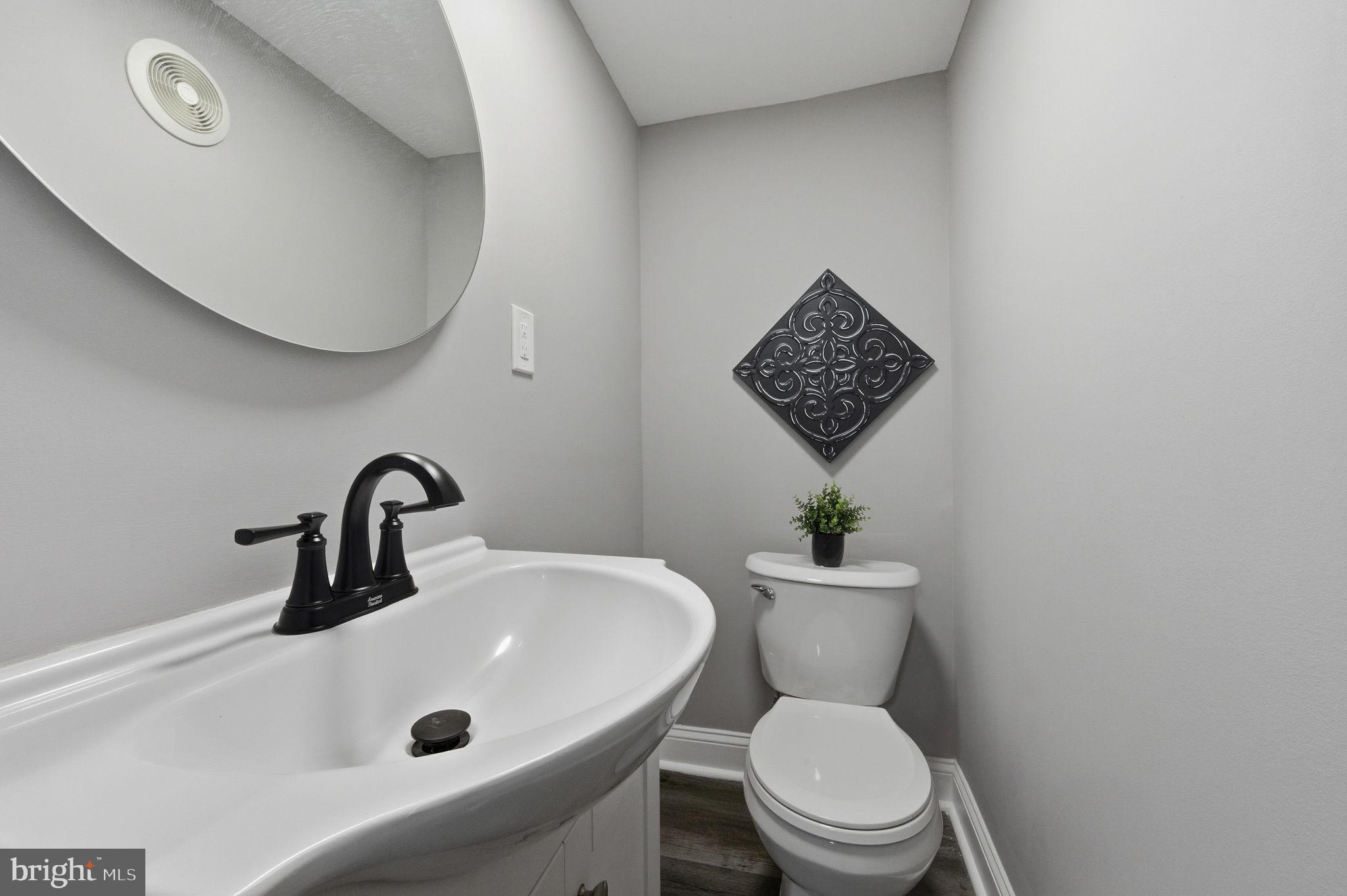 2247 Silverside Road Wilmington, DE 19810 - Photo 34 of 35 a bathroom with a toilet sink and mirror