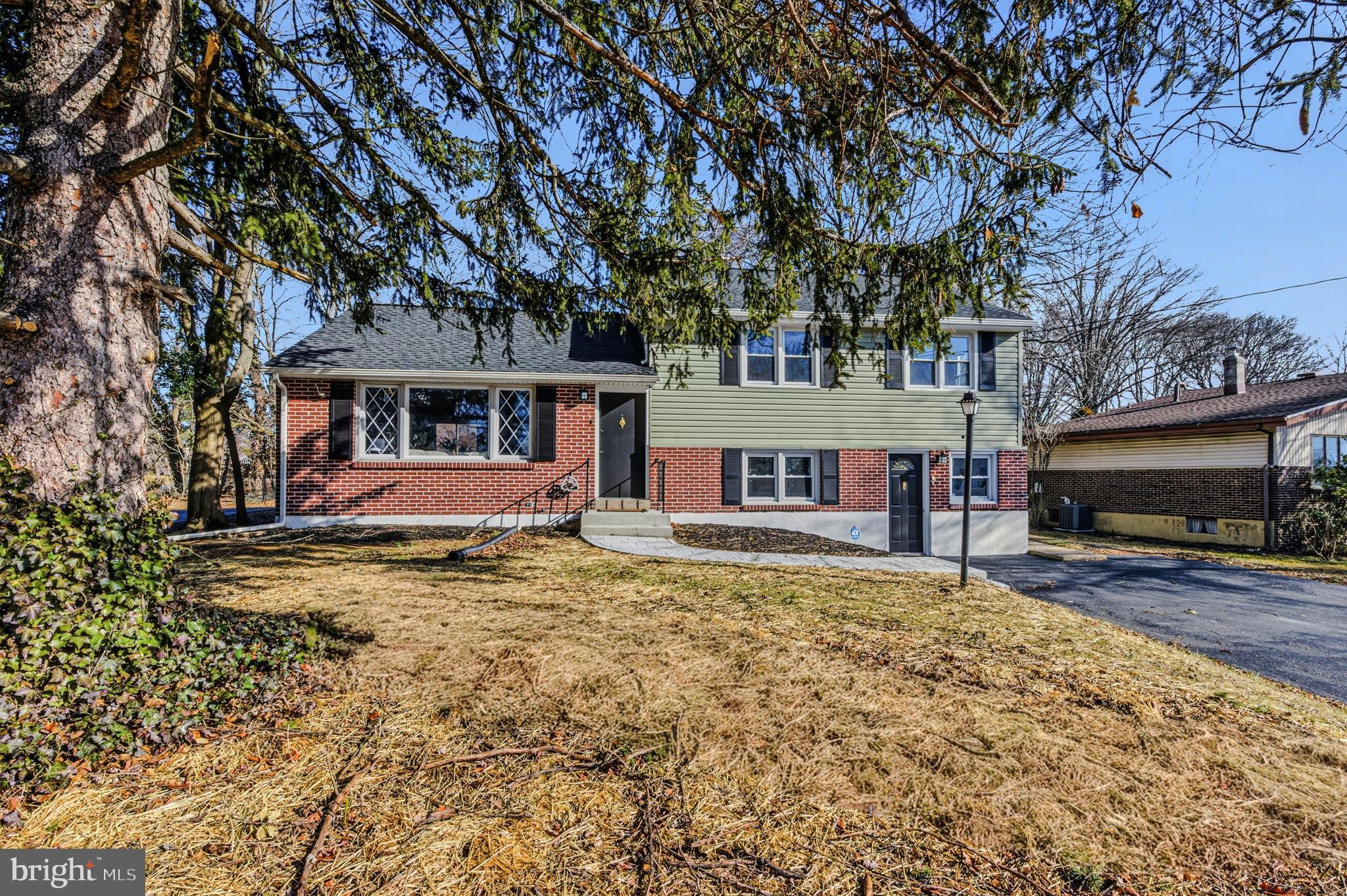 2247 Silverside Road Wilmington, DE 19810 - Photo 5 of 35 a view of a house with a large tree and a yard