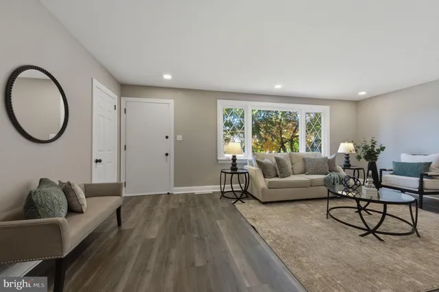 a living room with furniture a window and a lamp
