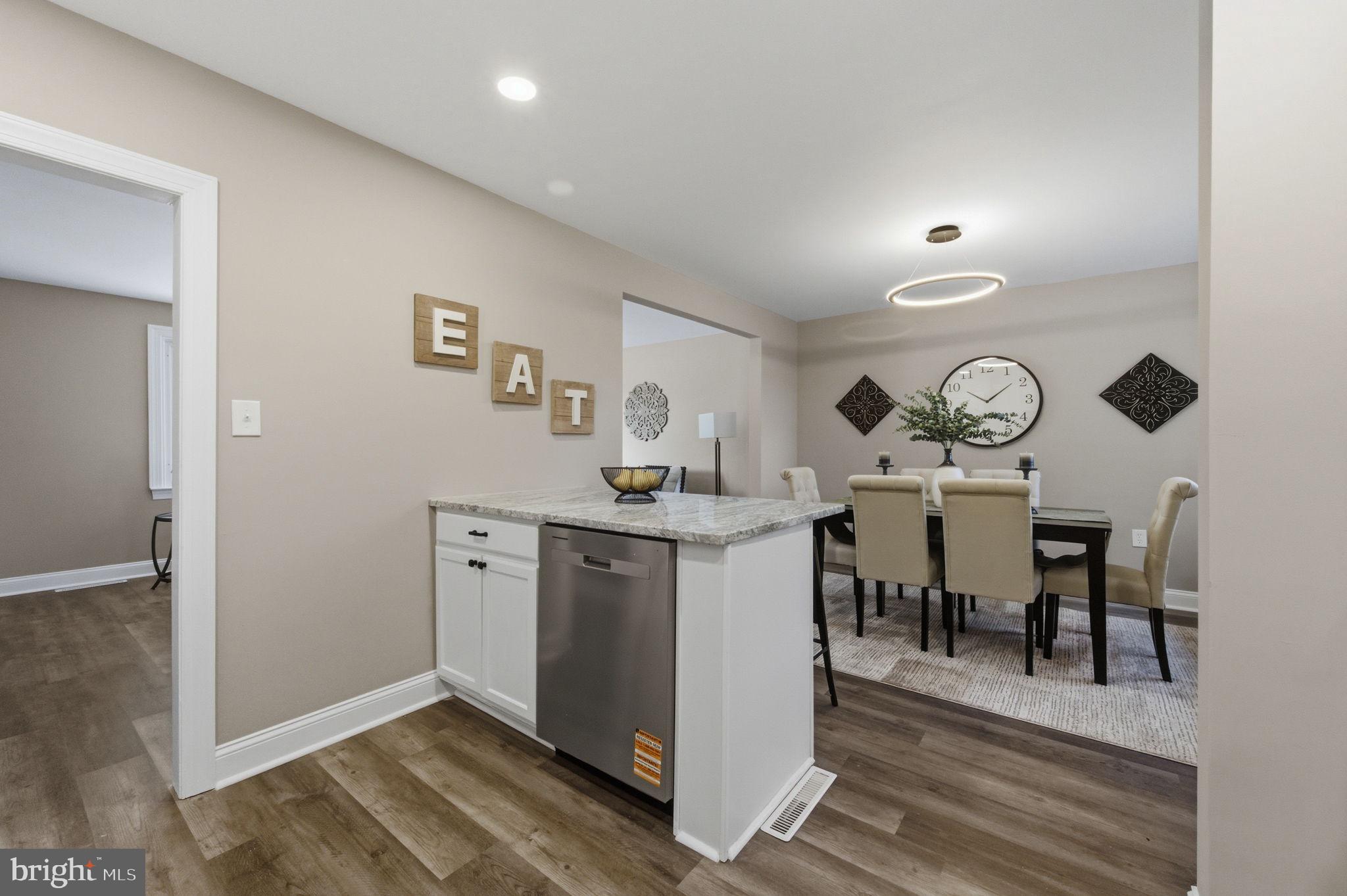 2247 Silverside Road Wilmington, DE 19810 - Photo 10 of 33 a view of dining room and kitchen with wooden floor
