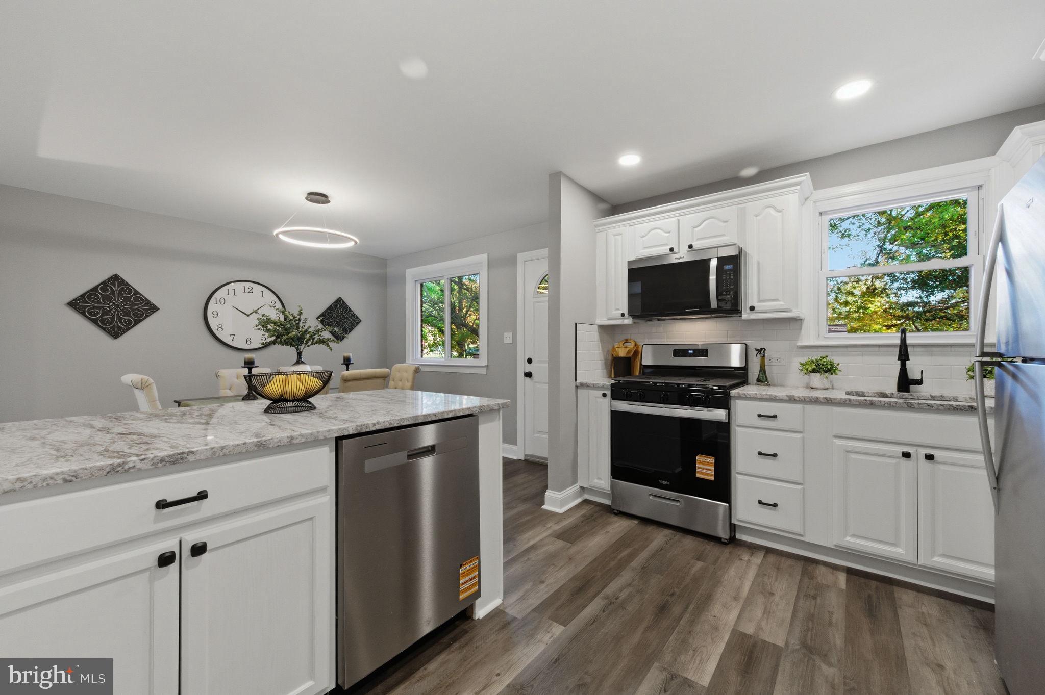 2247 Silverside Road Wilmington, DE 19810 - Photo 10 of 35 a kitchen with granite countertop a sink appliances cabinets and a counter top space