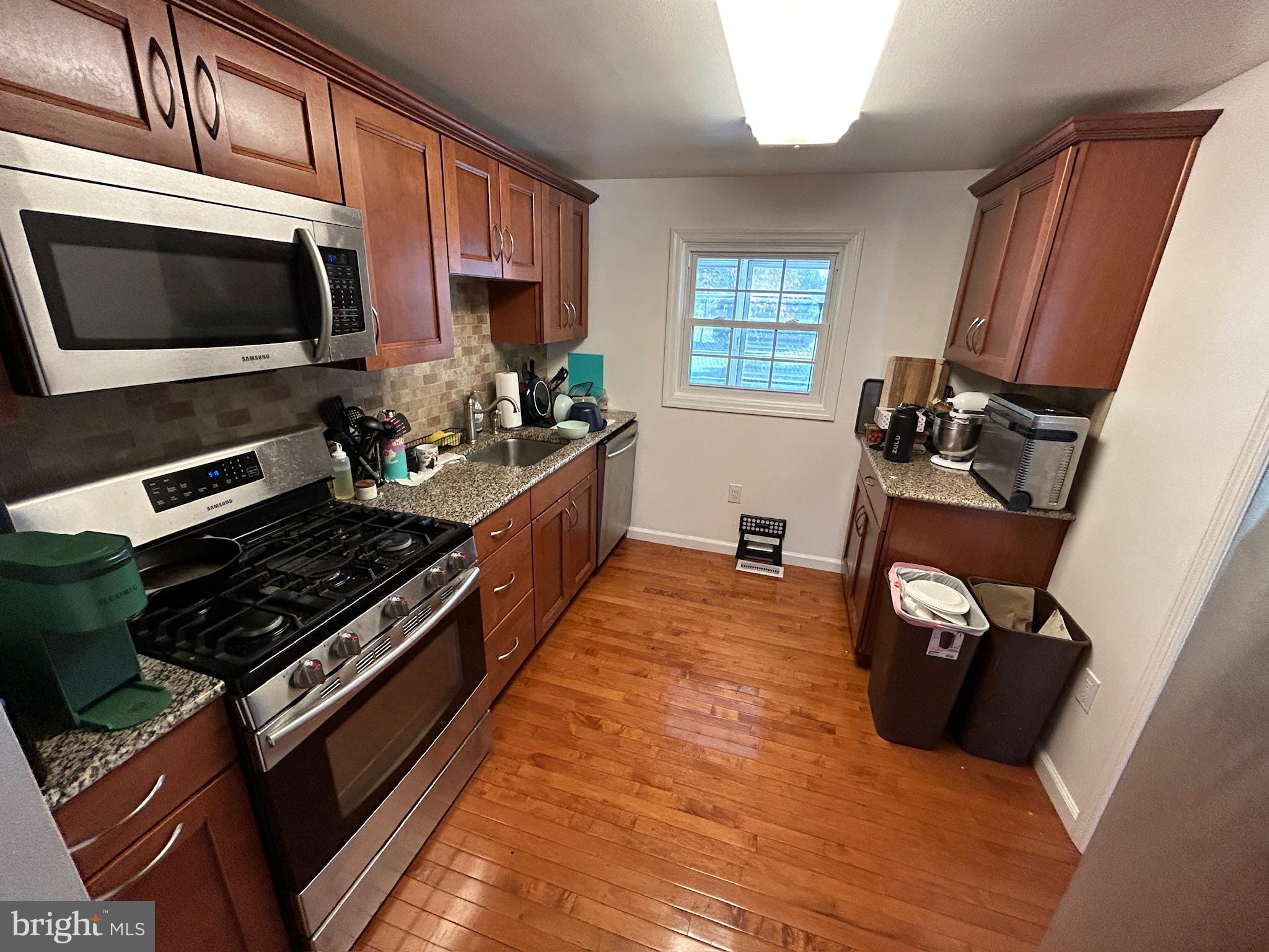 14 Georgetown Road Glassboro, NJ 08028 - Photo 7 of 15 a kitchen with granite countertop a stove and a microwave