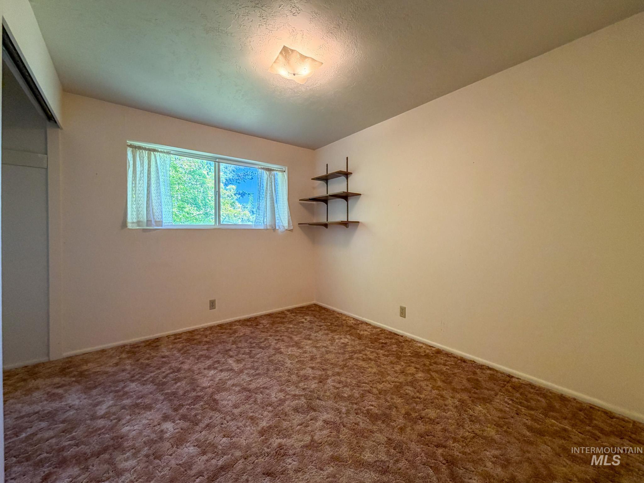 1924 H Street Rupert, ID 83350 - Photo 5 of 13 Carpeted interior space with neutral wall tones