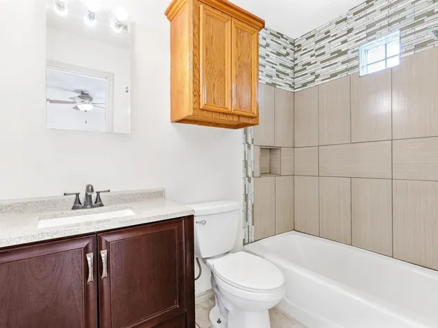 a bathroom with a sink a toilet and bathtub