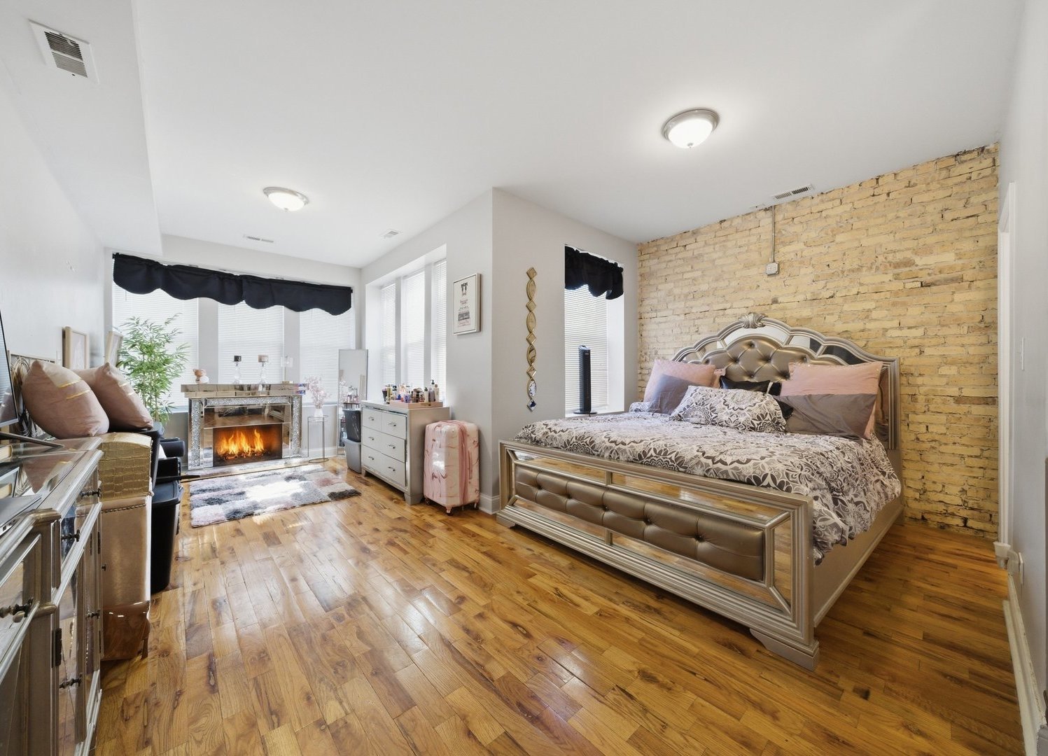 1253 South Tripp Avenue Chicago, IL 60623 - Photo 14 of 21 a bedroom with a bed a fireplace and two large window