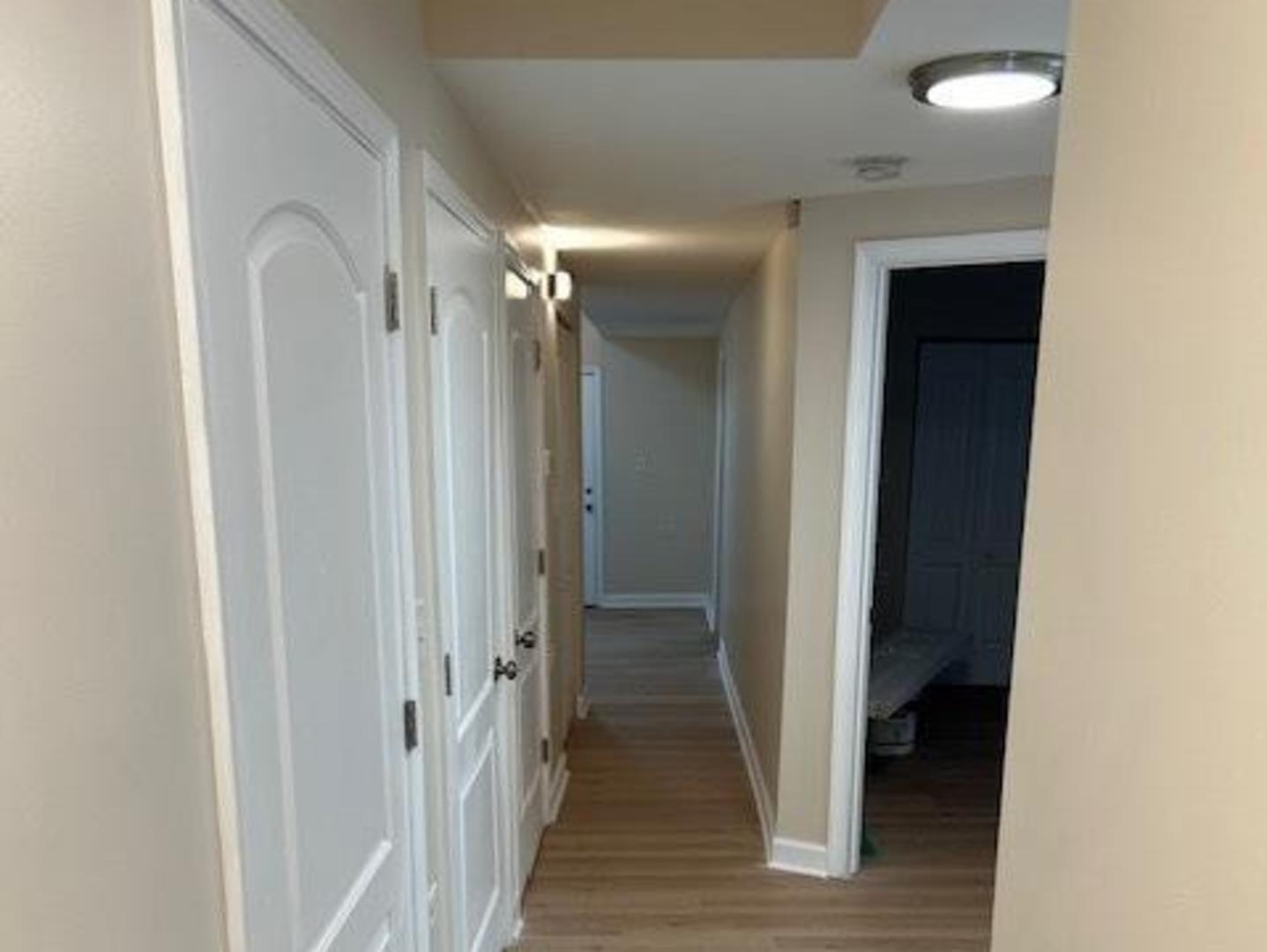 1253 South Tripp Avenue Chicago, IL 60623 - Photo 17 of 21 a view of a hallway with wooden floor