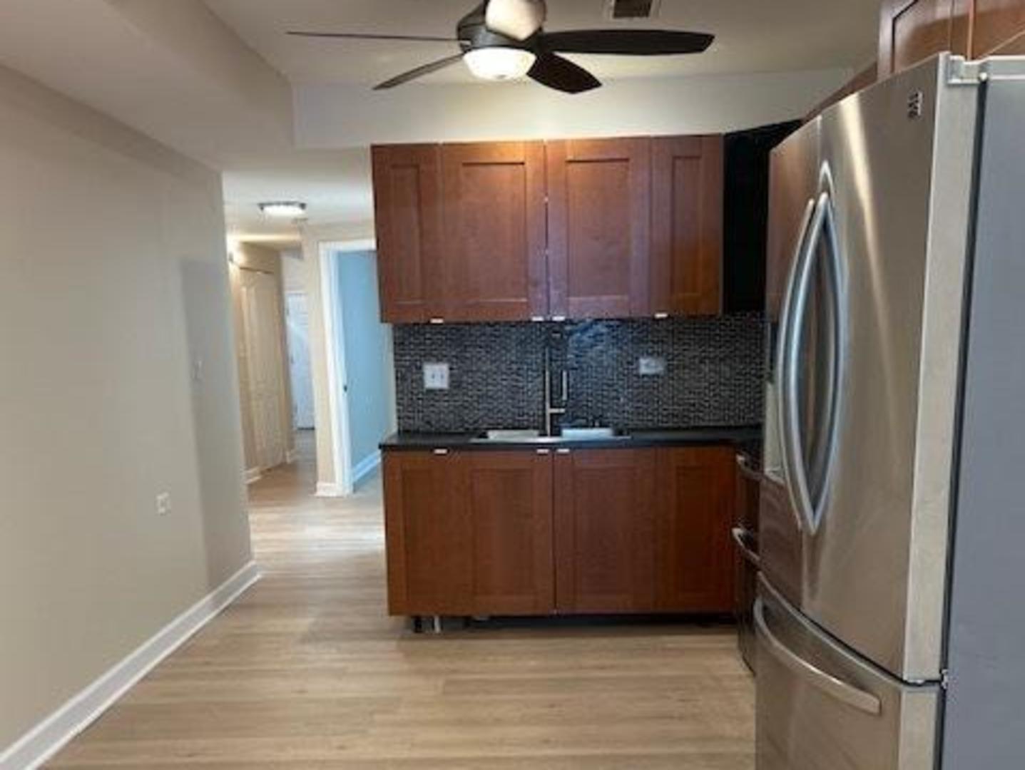 1253 South Tripp Avenue Chicago, IL 60623 - Photo 18 of 21 a view of kitchen with stainless steel appliances granite countertop a refrigerator and a sink