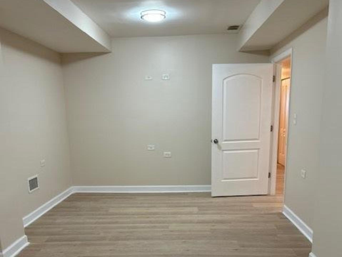 1253 South Tripp Avenue Chicago, IL 60623 - Photo 19 of 21 a view of an empty room with wooden floor