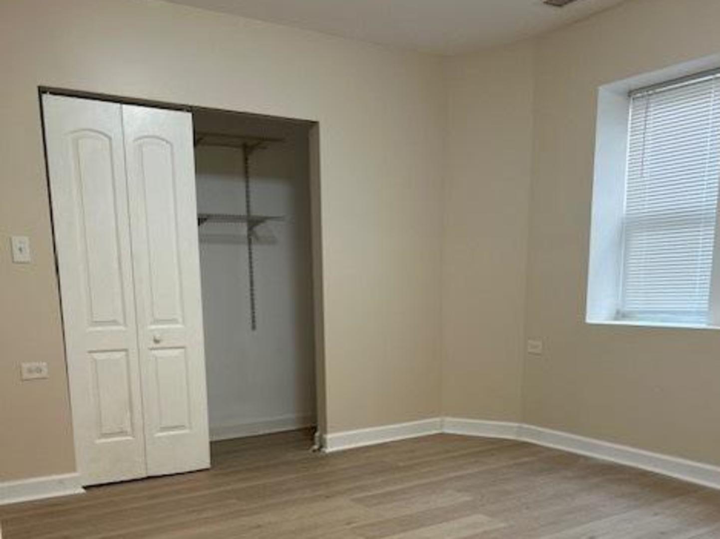 1253 South Tripp Avenue Chicago, IL 60623 - Photo 20 of 21 an empty room with wooden floor and closet area