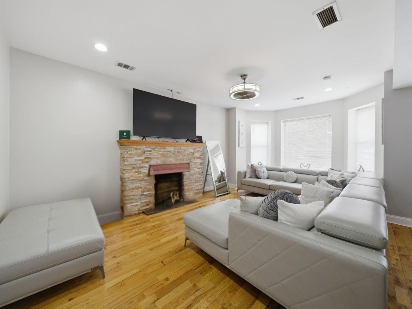 1253 South Tripp Avenue Chicago, IL 60623 - Photo 3 of 21 a living room with furniture a fireplace and a flat screen tv