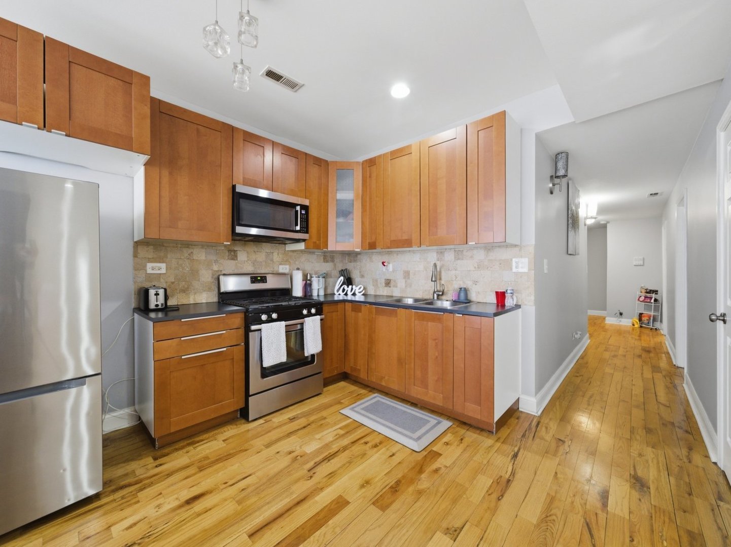 1253 South Tripp Avenue Chicago, IL 60623 - Photo 5 of 21 a kitchen with granite countertop a refrigerator stove top oven and sink