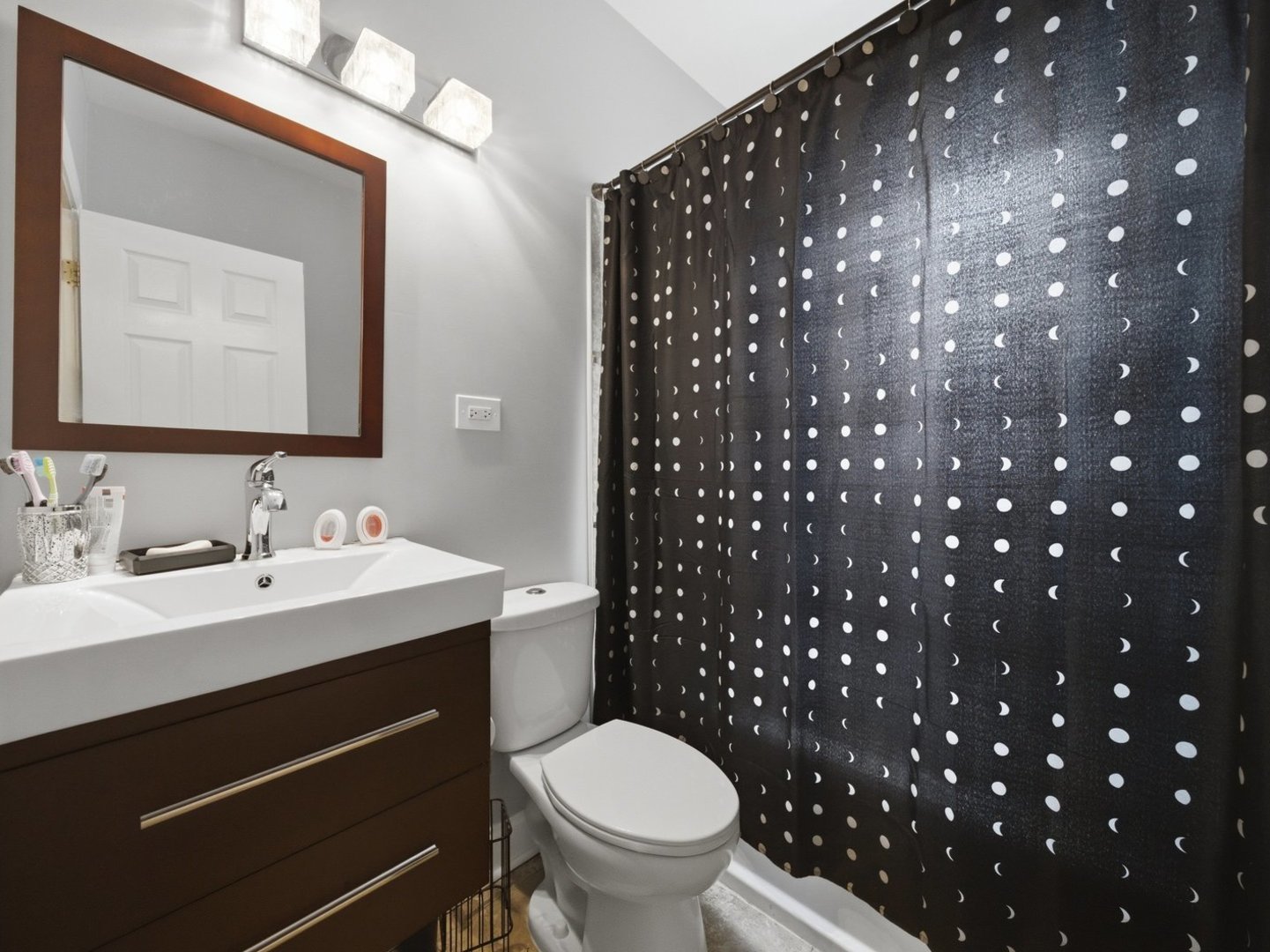1253 South Tripp Avenue Chicago, IL 60623 - Photo 6 of 21 a bathroom with a toilet a sink and a mirror