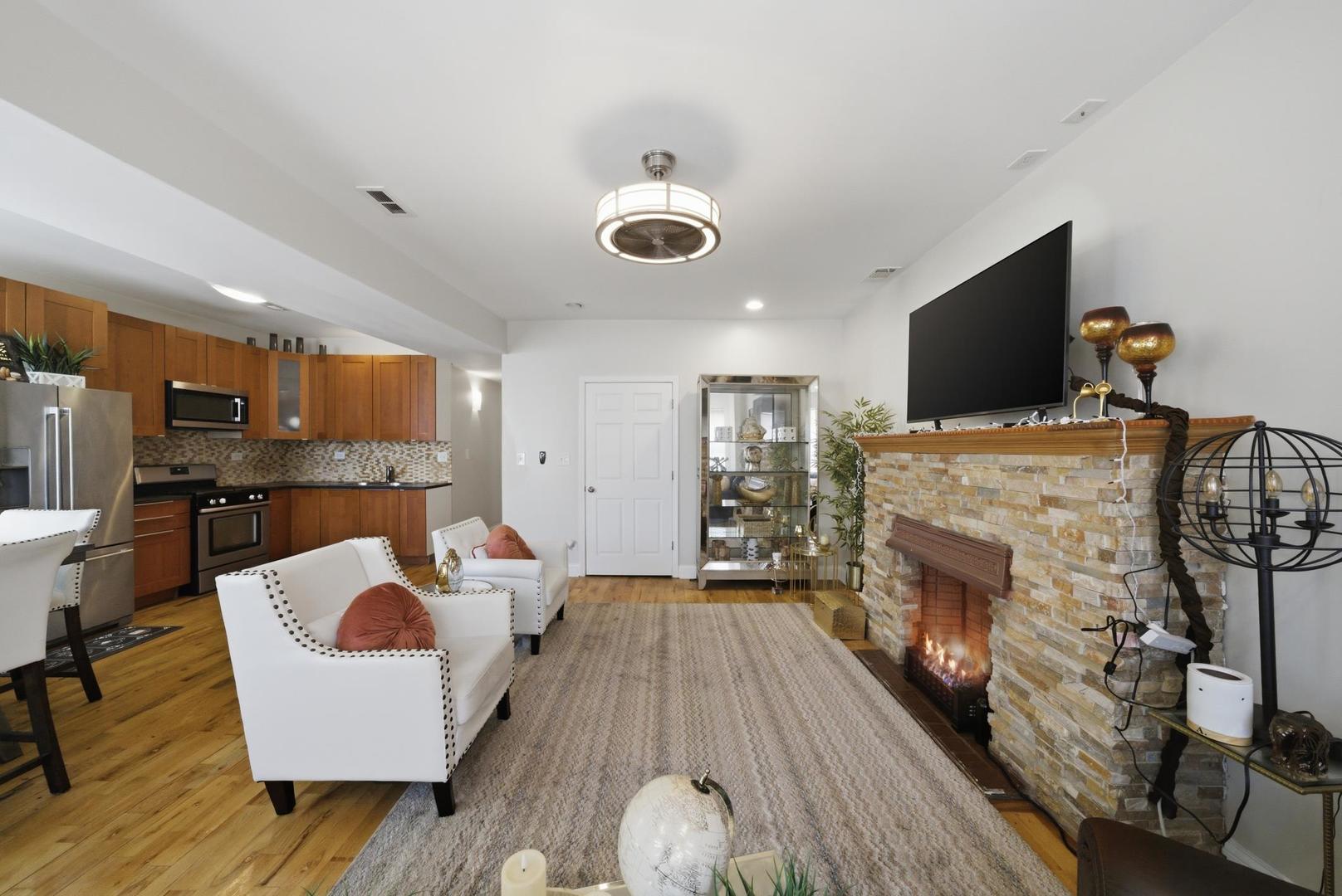 1253 South Tripp Avenue Chicago, IL 60623 - Photo 10 of 21 a living room with furniture and a fireplace