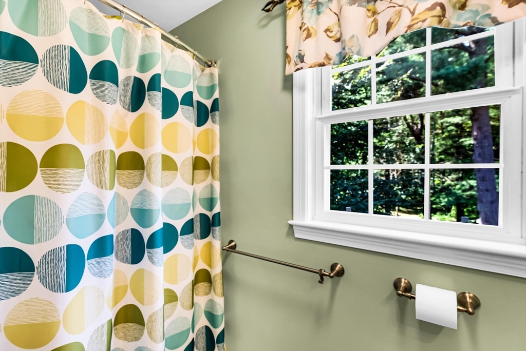 46 A School Street Upton, MA 01568 - Photo 24 of 42 a bathroom with a window and a shower curtain