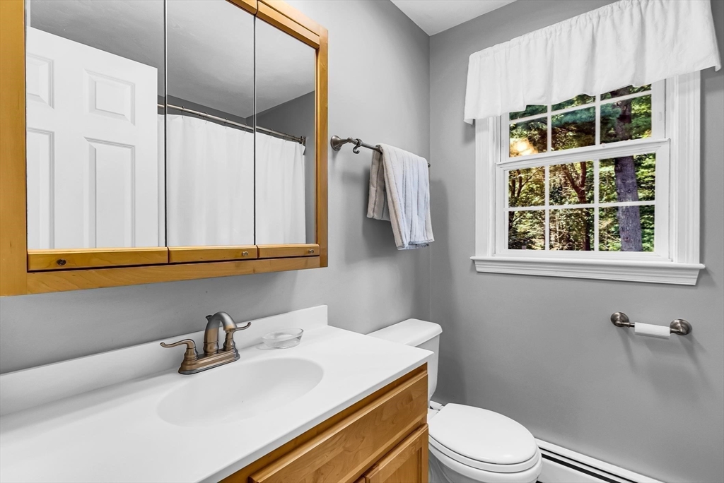 46 A School Street Upton, MA 01568 - Photo 25 of 42 a bathroom with a sink vanity mirror and toilet