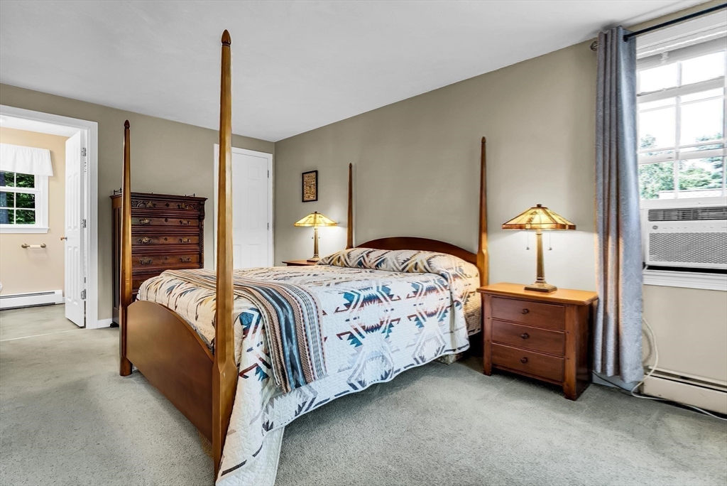 46 A School Street Upton, MA 01568 - Photo 28 of 42 a bedroom with a bed next to a window