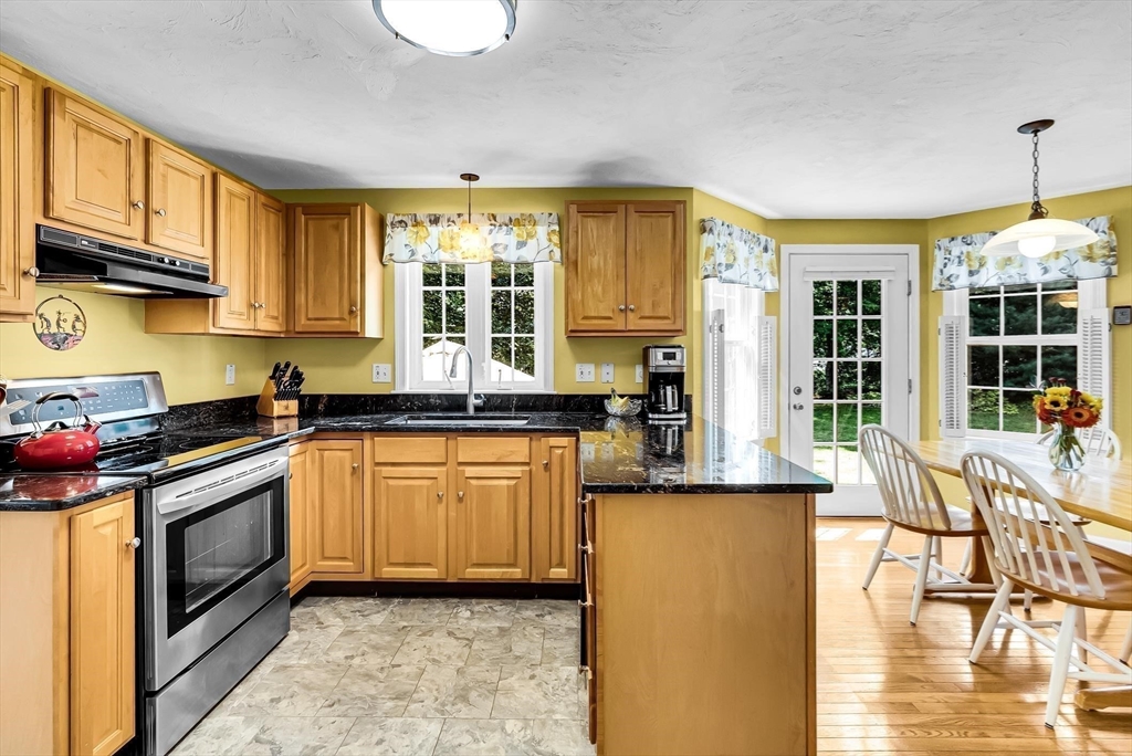 46 A School Street Upton, MA 01568 - Photo 3 of 42 a kitchen with stainless steel appliances granite countertop a stove a sink and a microwave