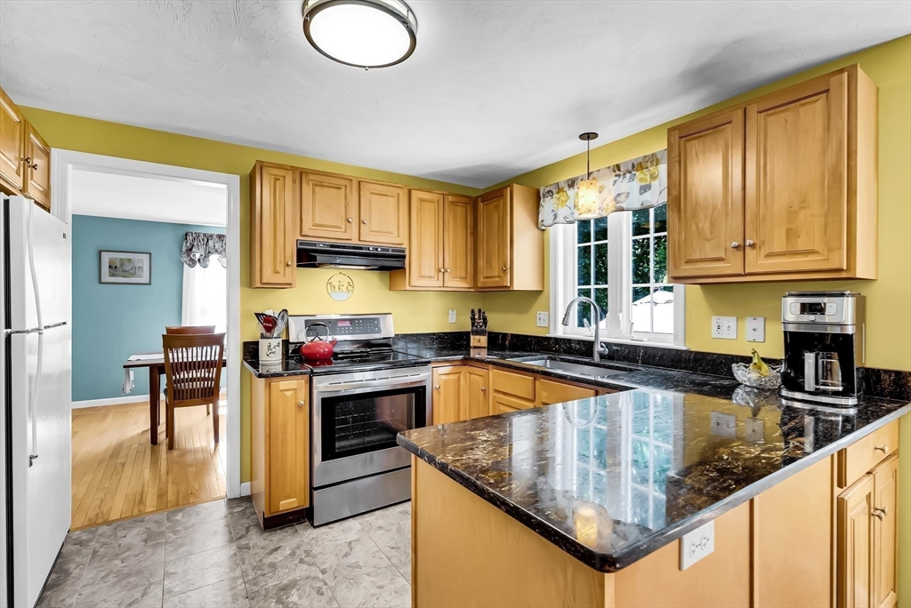46 A School Street Upton, MA 01568 - Photo 4 of 42 a kitchen with stainless steel appliances granite countertop a stove sink and cabinets