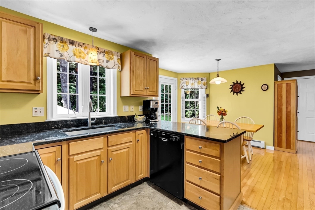 46 A School Street Upton, MA 01568 - Photo 5 of 42 a kitchen with granite countertop a sink and cabinets