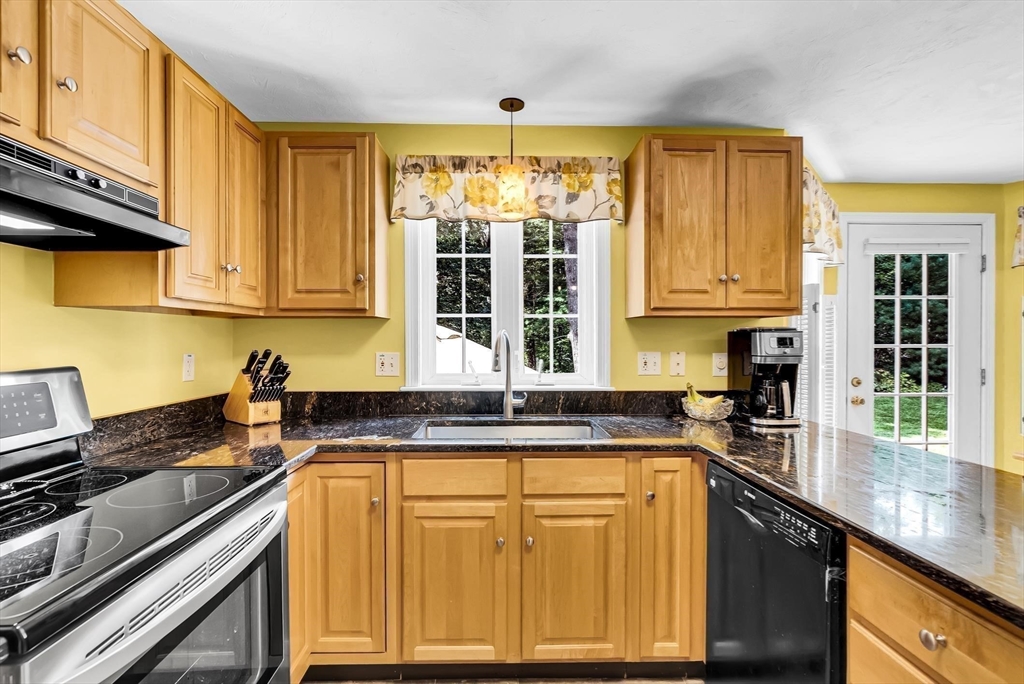 46 A School Street Upton, MA 01568 - Photo 6 of 42 a kitchen with granite countertop cabinets stainless steel appliances a sink and window