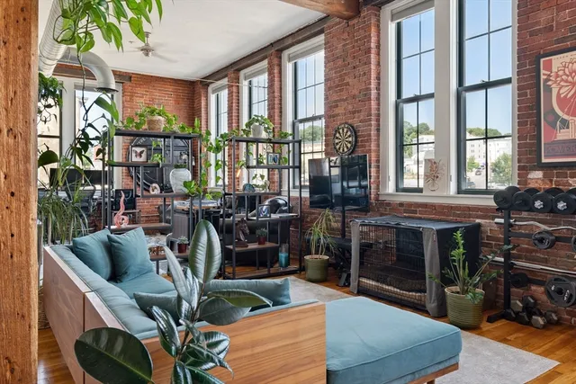 a view of a livingroom with furniture and staircase