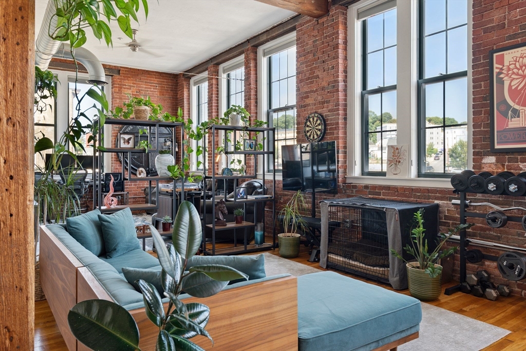 13-17 Willow Street, Unit 206 Lynn, MA 01901 - Photo 11 of 39 a view of a livingroom with furniture and staircase