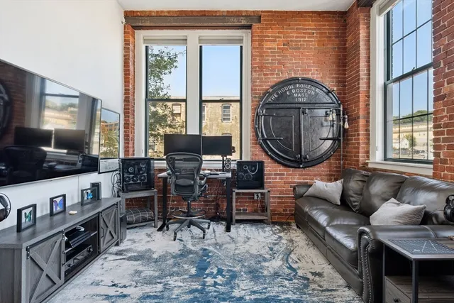 a living room with furniture a flat screen tv and a large window