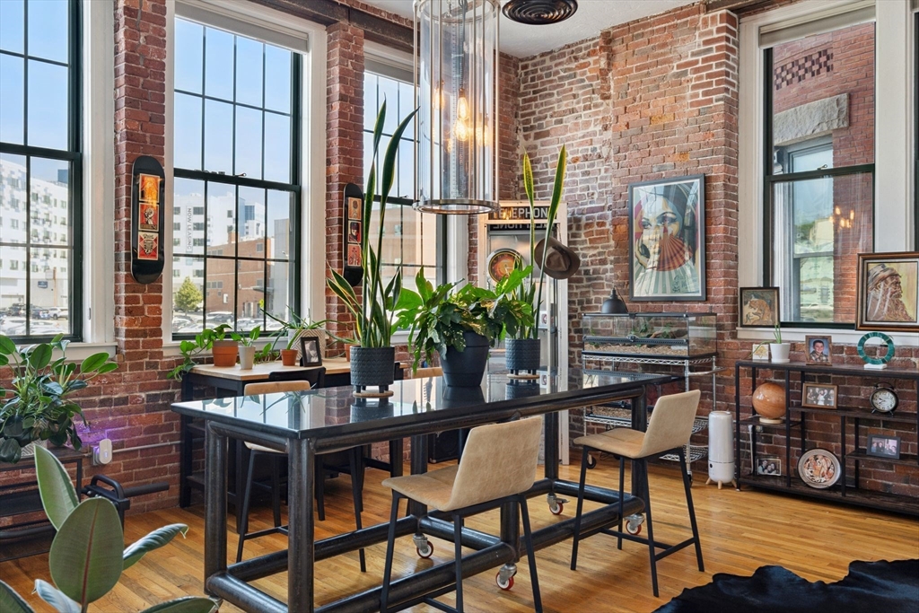 13-17 Willow Street, Unit 206 Lynn, MA 01901 - Photo 19 of 39 a table and chairs in front of a building