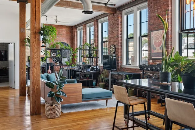 a dining room with furniture window and wooden floor