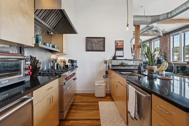 a kitchen with stainless steel appliances a sink and a stove