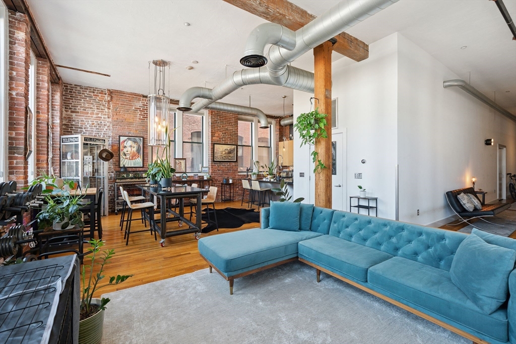 13-17 Willow Street, Unit 206 Lynn, MA 01901 - Photo 21 of 39 a living room with furniture and a large window