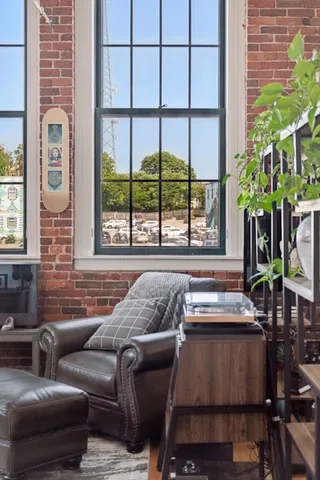 a living room with furniture and a potted plant