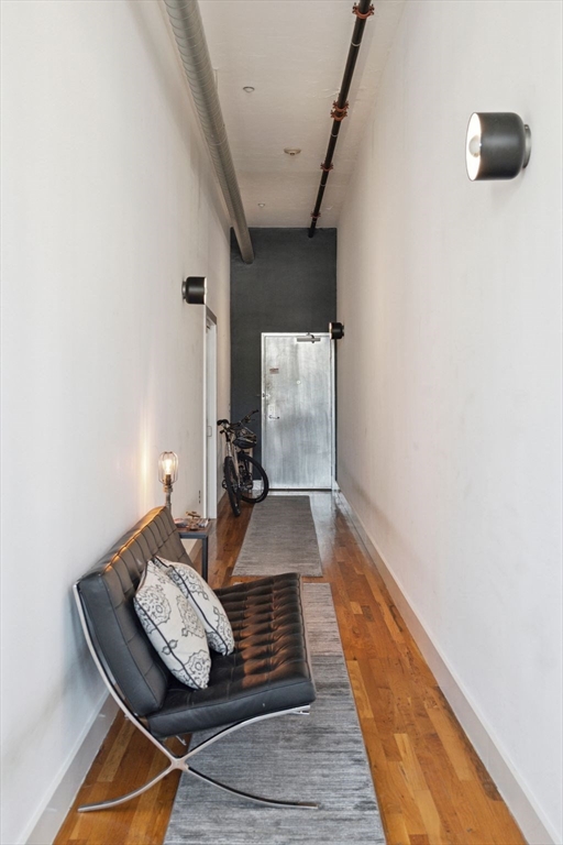 13-17 Willow Street, Unit 206 Lynn, MA 01901 - Photo 28 of 39 a room with wooden floor and furniture