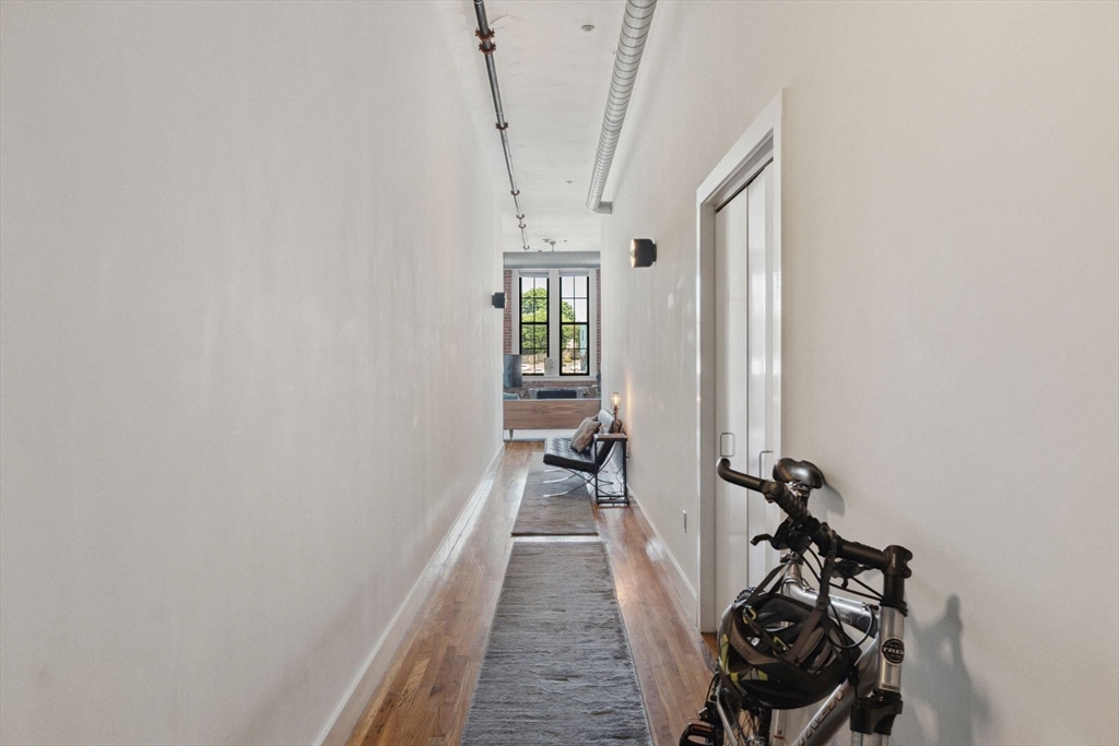 13-17 Willow Street, Unit 206 Lynn, MA 01901 - Photo 30 of 39 a view of a room with rack on the wall and a window