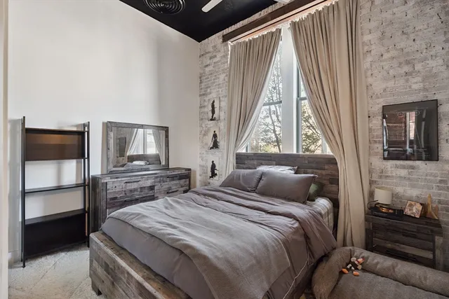 a bedroom with a bed and a window