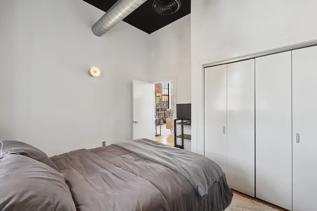 a bedroom with a bed and a closet