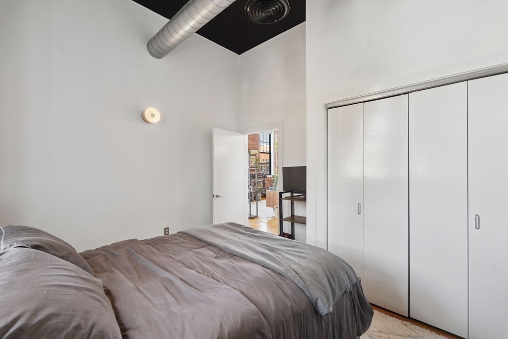 13-17 Willow Street, Unit 206 Lynn, MA 01901 - Photo 37 of 39 a bedroom with a bed and a closet