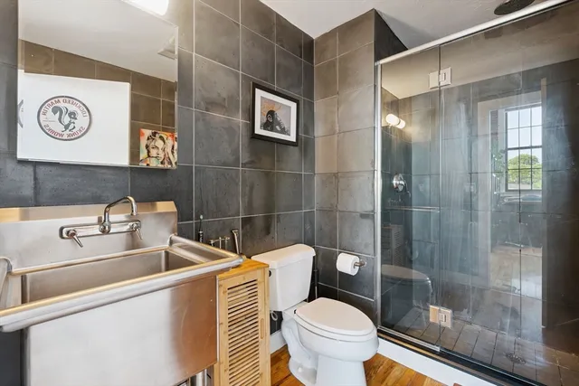 a bathroom with a sink toilet and shower